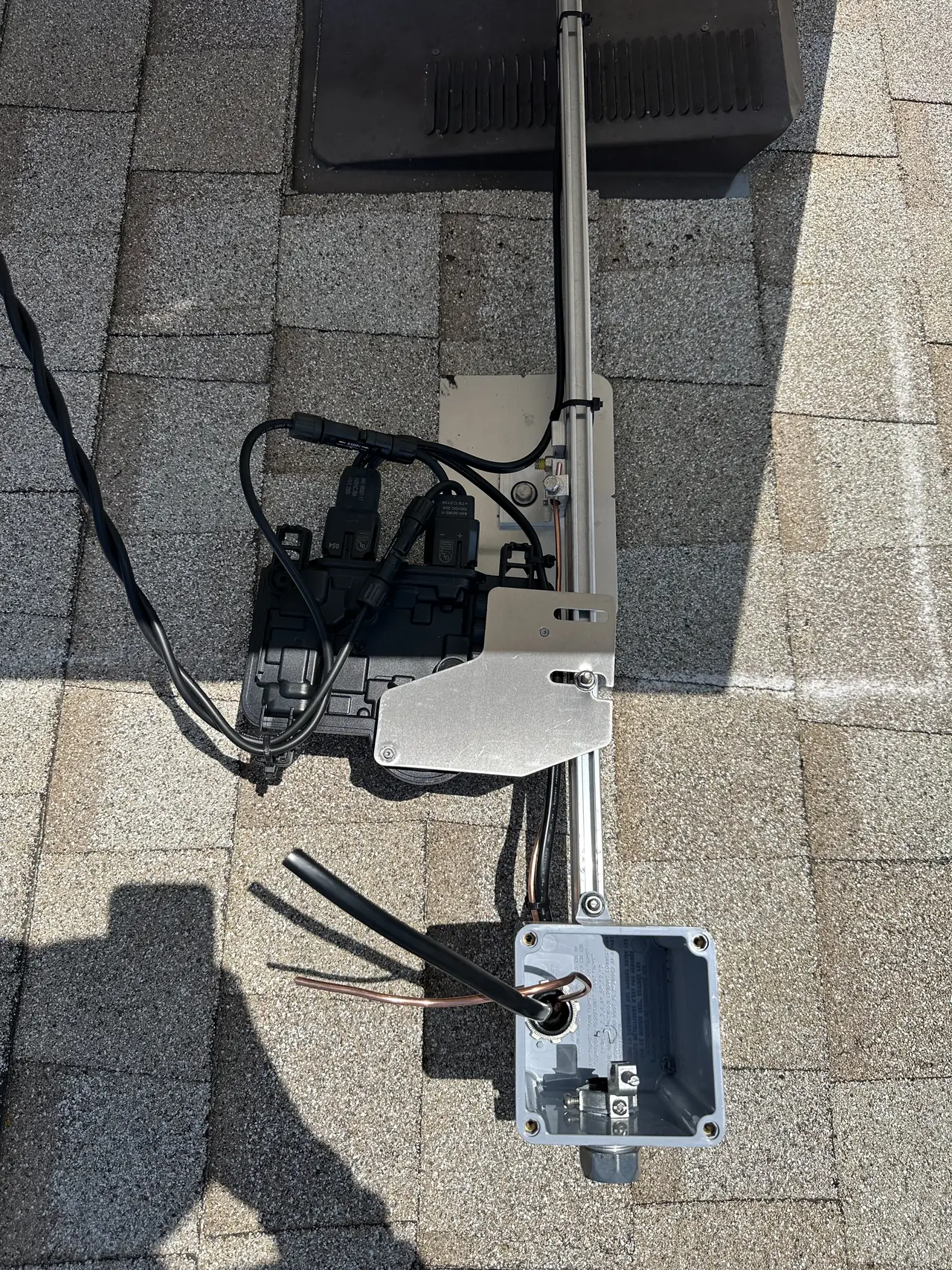 Microinverters and a junction box mounted on rails beneath a module, Northridge