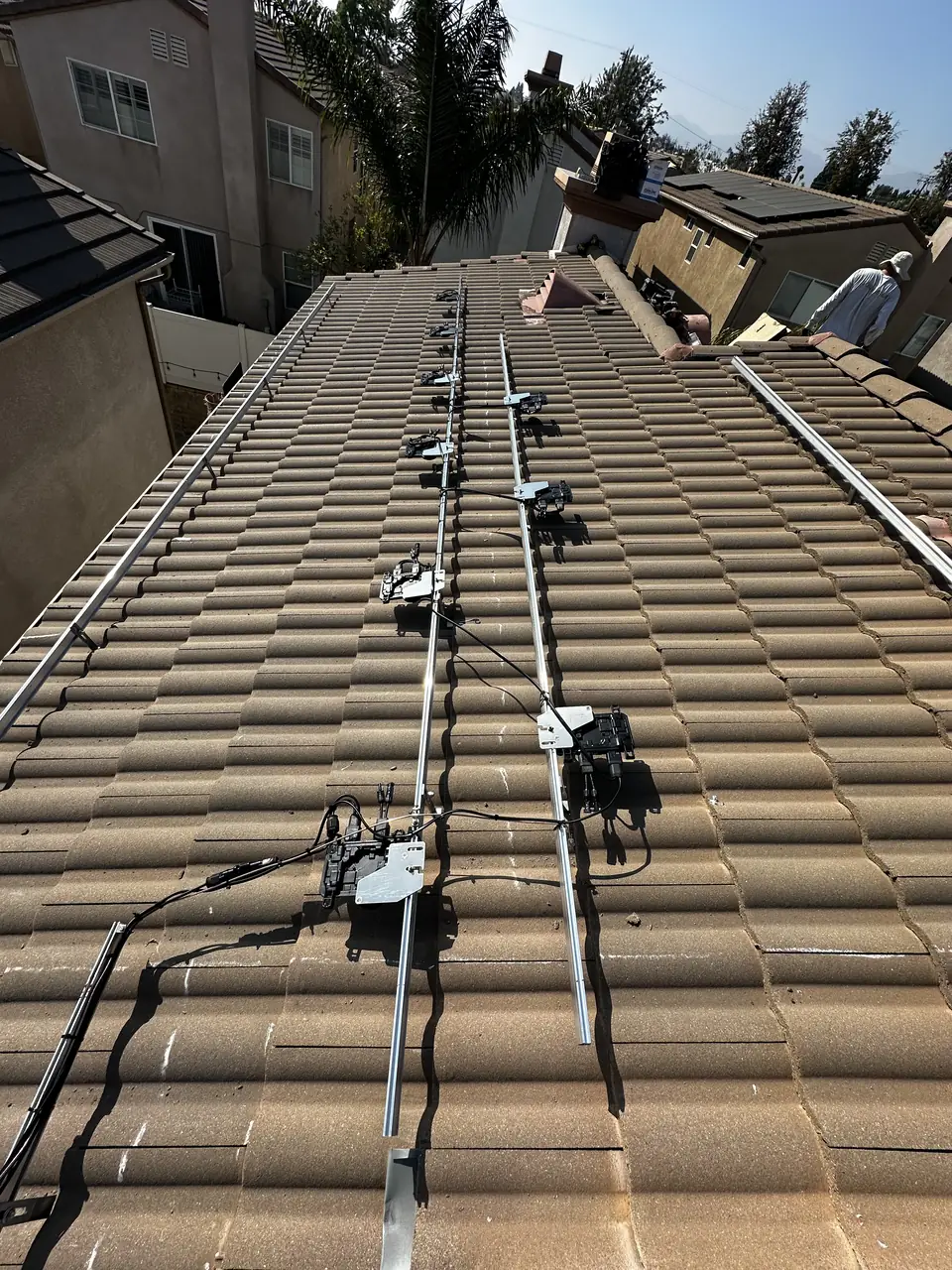 Sixteen REC panels with Enphase IQ8A microinverters on a tile roof in Pacoima
