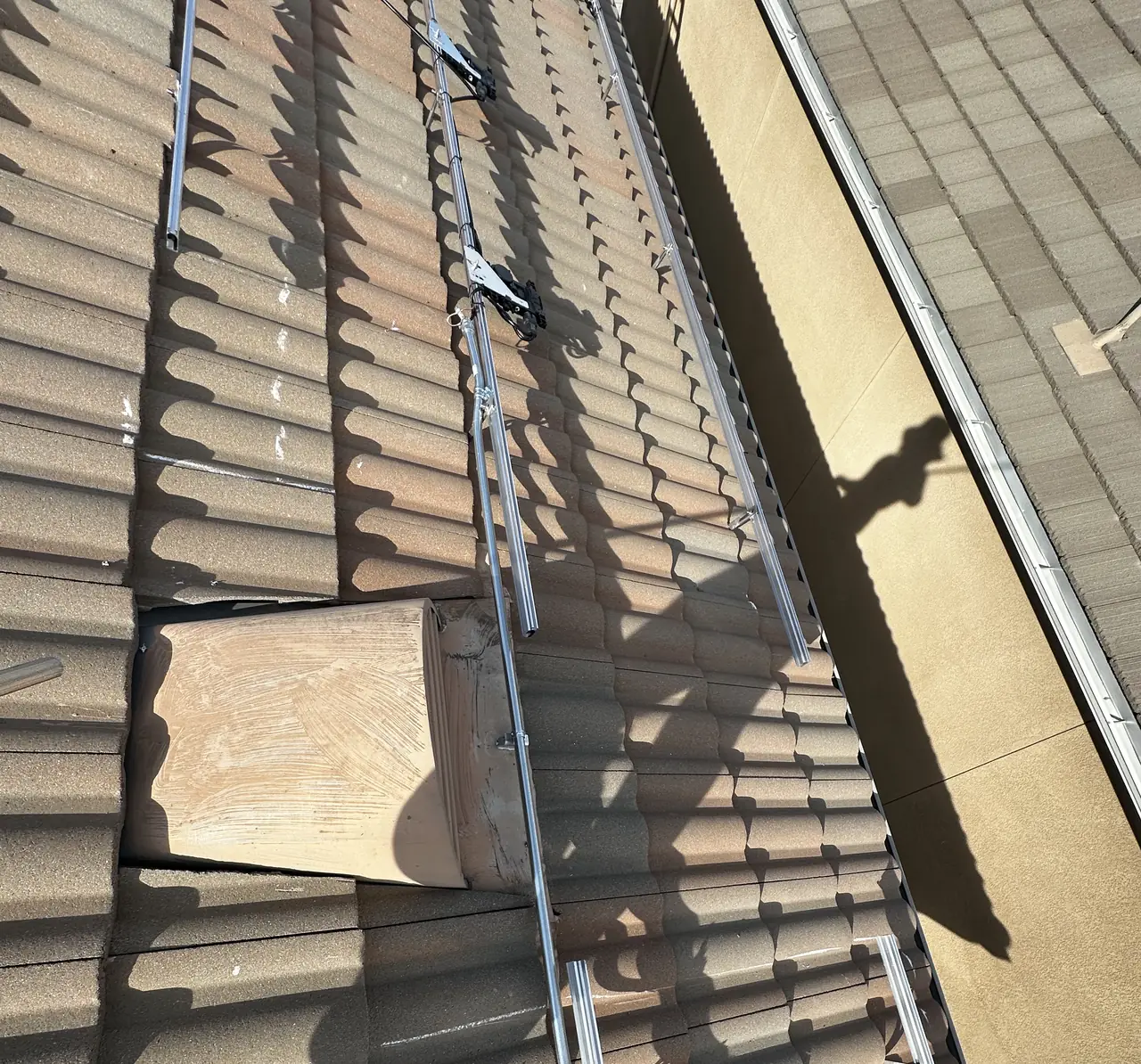 Concrete tile lifted along a rail line with the mounting hardware visible underneath, Pacoima, Los Angeles