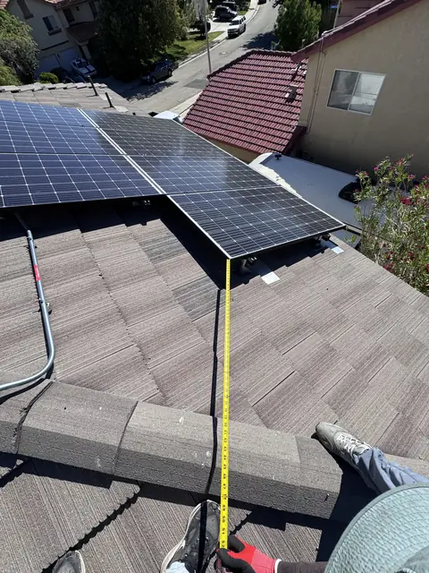 Solar panel mounting detail on a composition shingle roof in Palmdale, CA