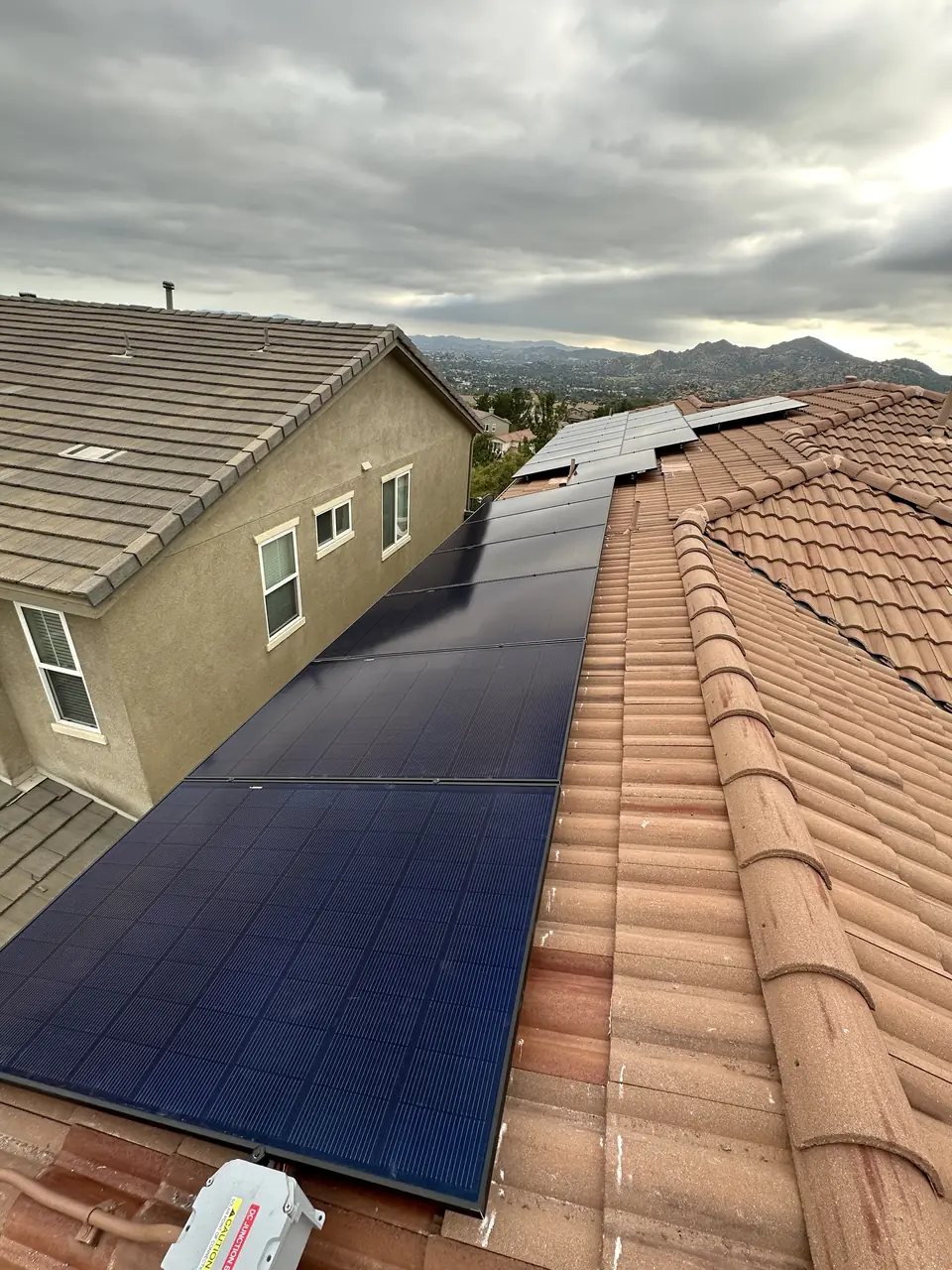 Twenty-four REC Alpha Pure-R panels on a tile roof in Porter Ranch