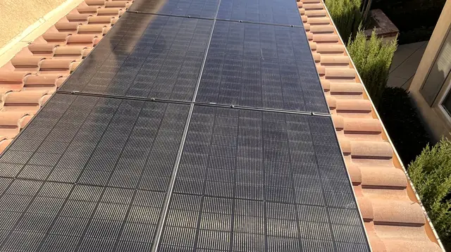Solar modules on a tile roof above a stucco wall, Porter Ranch