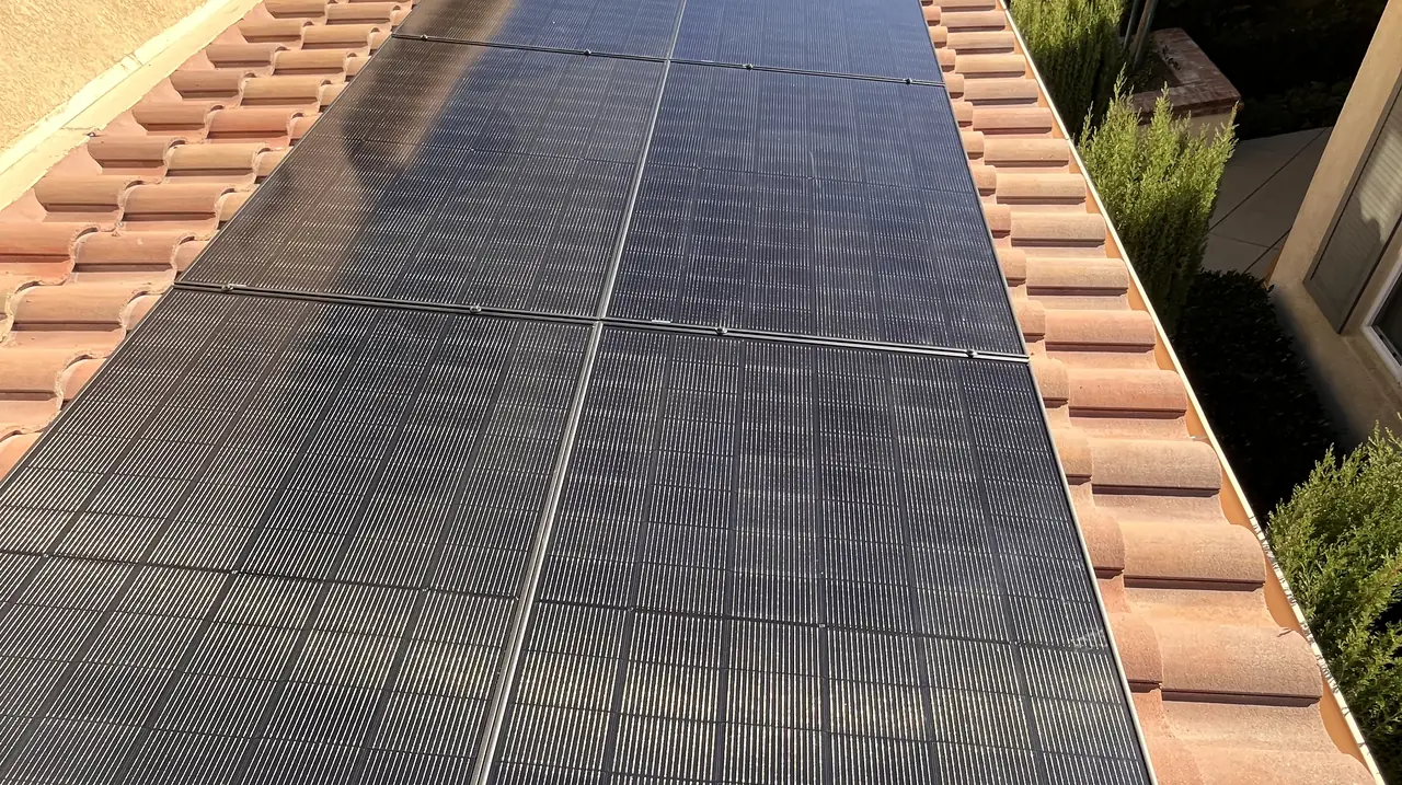 Solar modules on a tile roof above a stucco wall, Porter Ranch