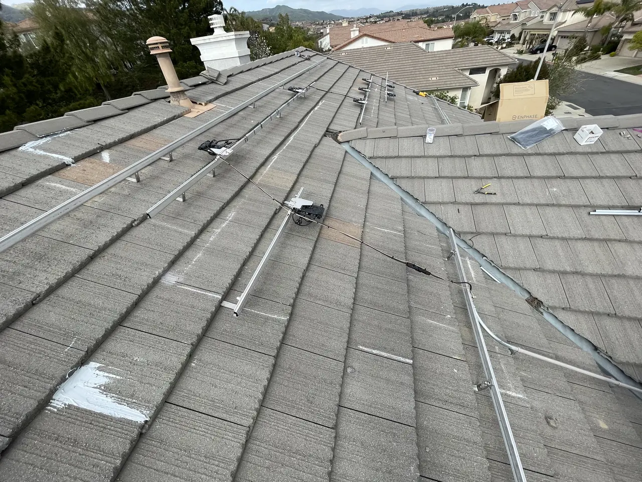 Mounting rails laid across a tile roof with clear pathways between the rows, Porter Ranch