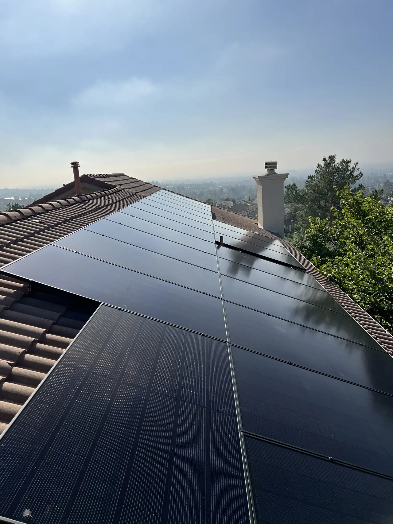 Solar modules on a tile roof with the valley behind them, Porter Ranch