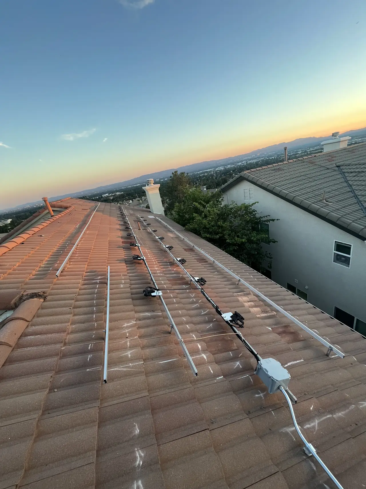 Conduit running across a tile roof toward the array, Porter Ranch