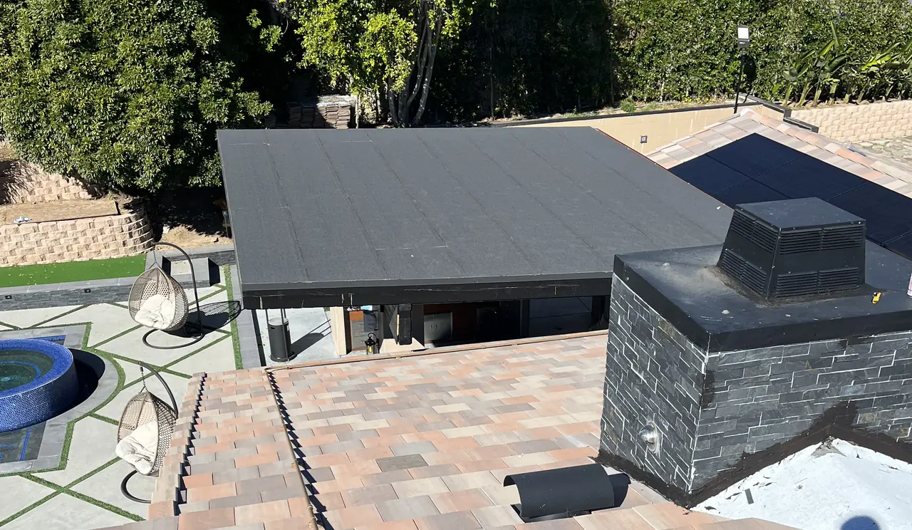A tile roof with a stone chimney and the array beyond it, Porter Ranch