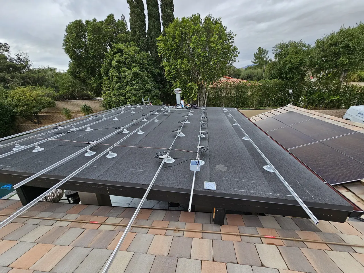 A solar array on a low-slope roof with the garden below, Porter Ranch