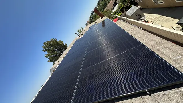 A solar array on a shingle roof against a clear sky, Porter Ranch