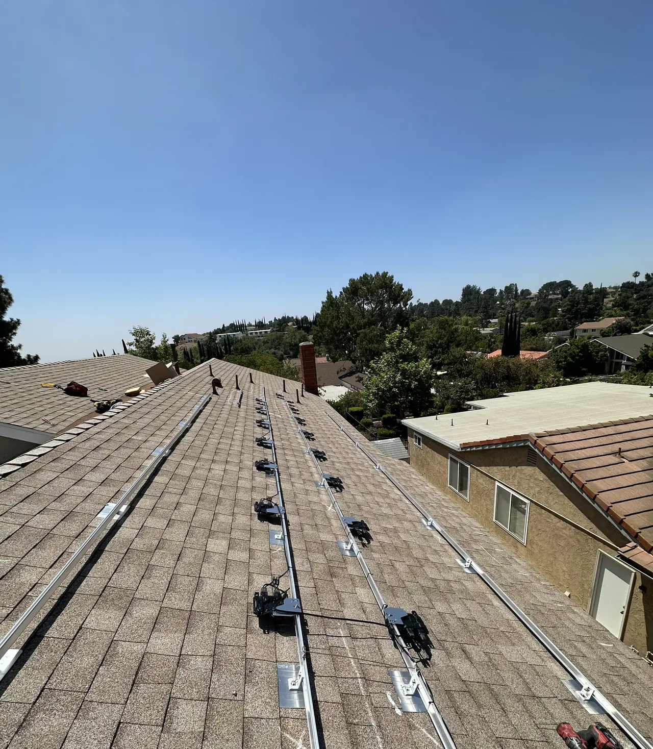 Mounting rails fixed along a shingle roof, Porter Ranch