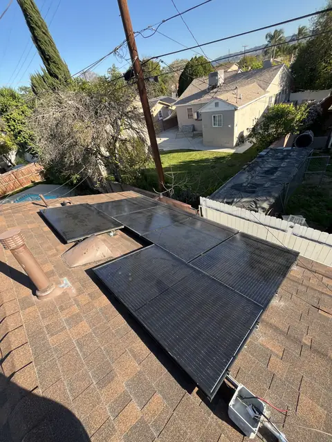 Solar panel mounting detail on a composition shingle roof in Reseda, CA