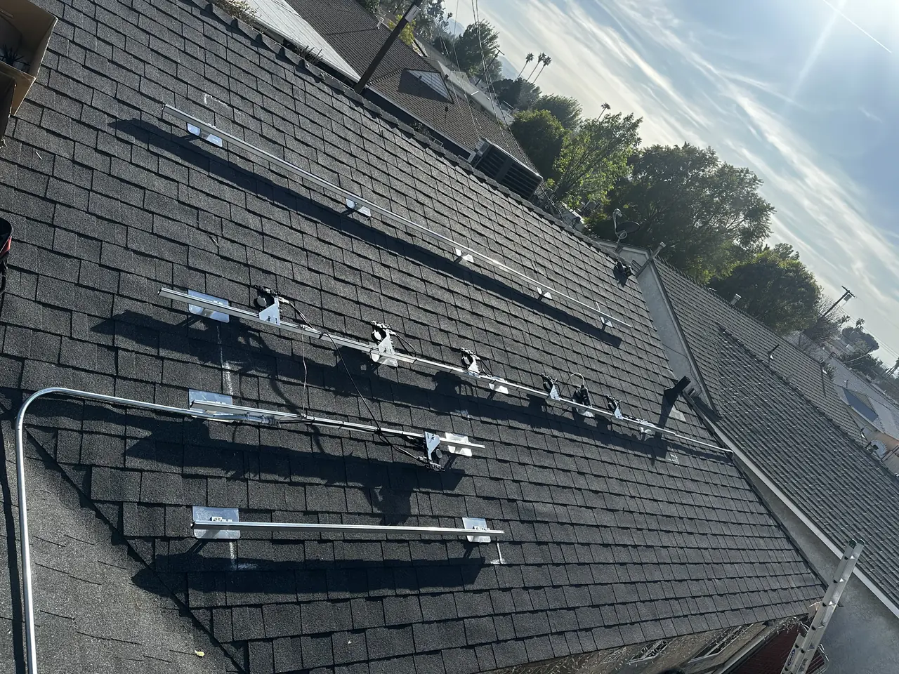 Solar panel mounting detail on a composition shingle roof in Reseda, CA