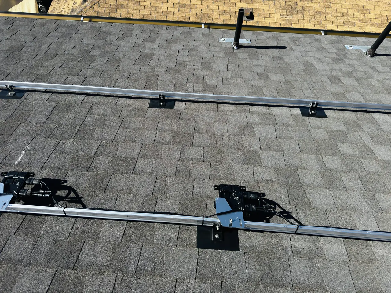 Mounting rails set out across new composition shingle before the modules go on, Reseda