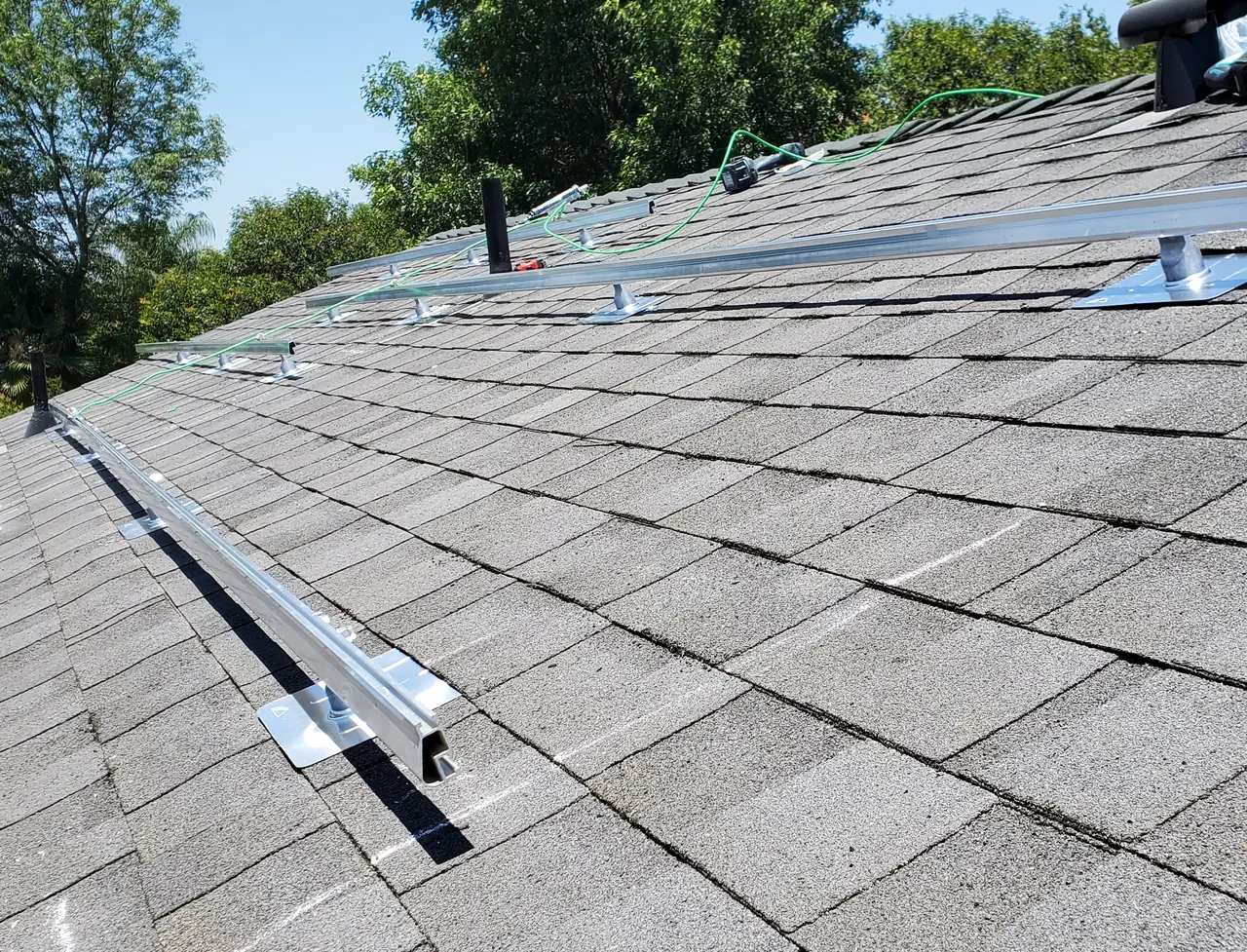 Mounting rails laid across the new composition shingle roof before the modules, Reseda