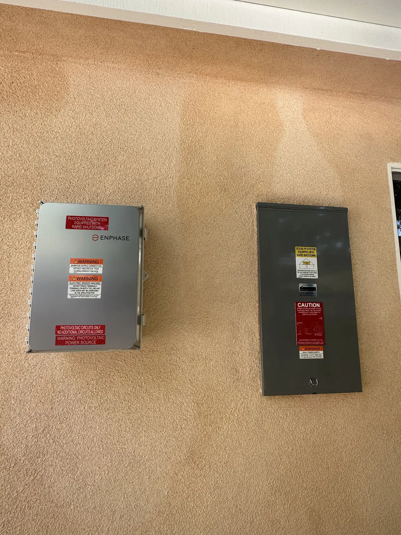 Two closed gray electrical enclosures mounted side by side on a stucco wall, Reseda