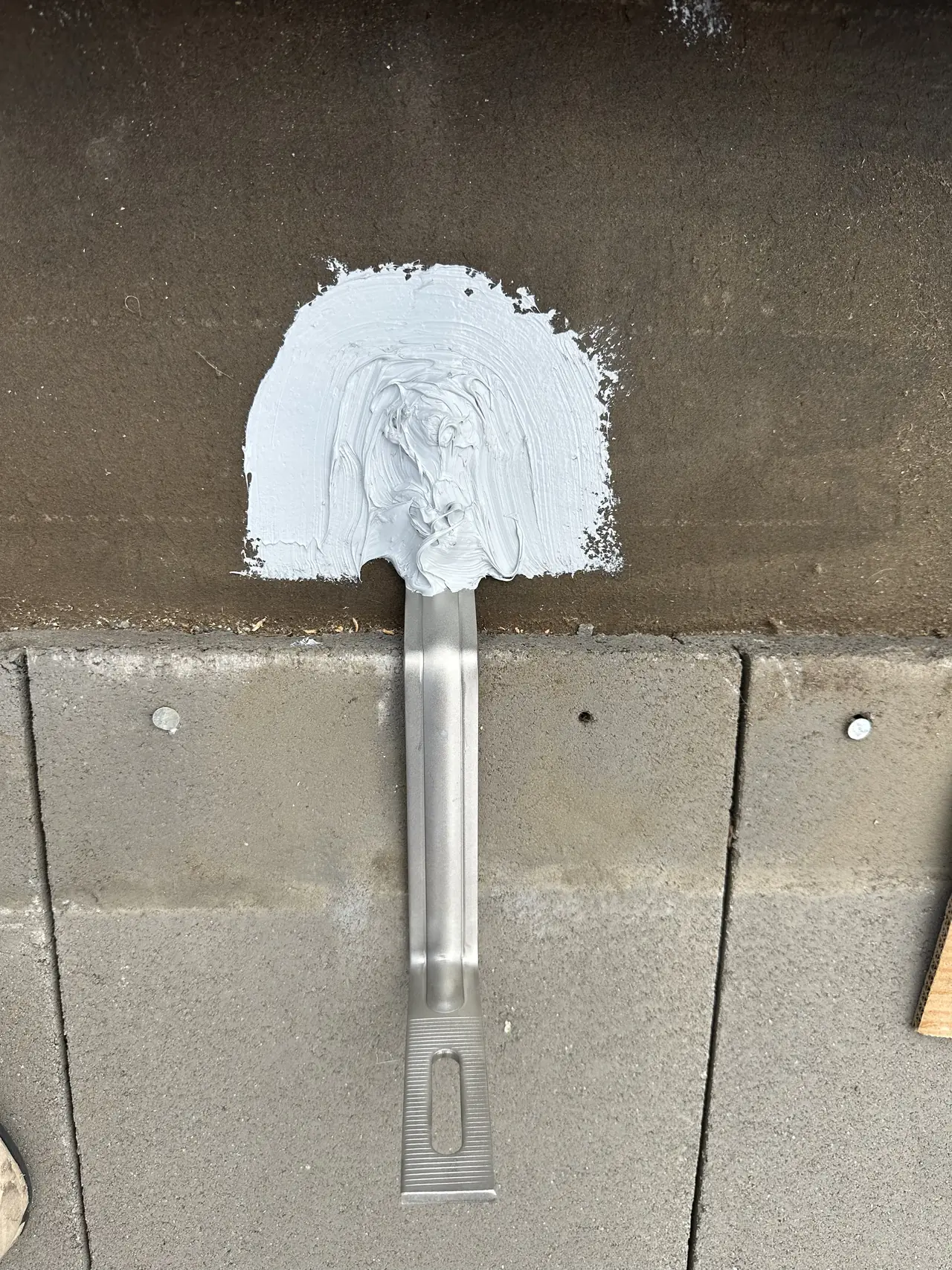 A cracked concrete roof tile with the crack sealed along its length, San Fernando