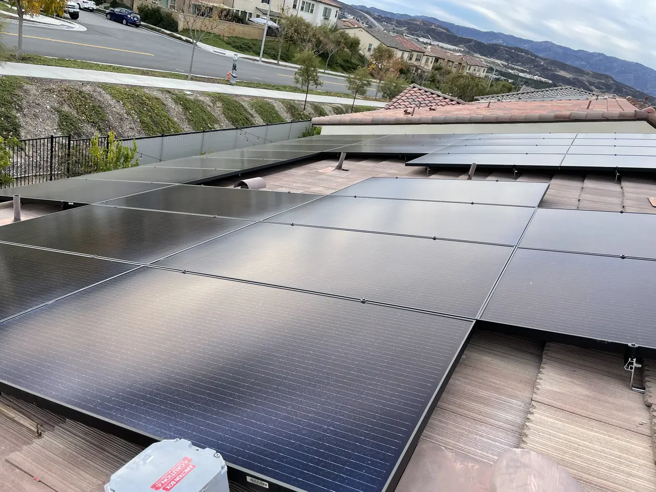 All-black solar array on a flat concrete tile roof in Santa Clarita