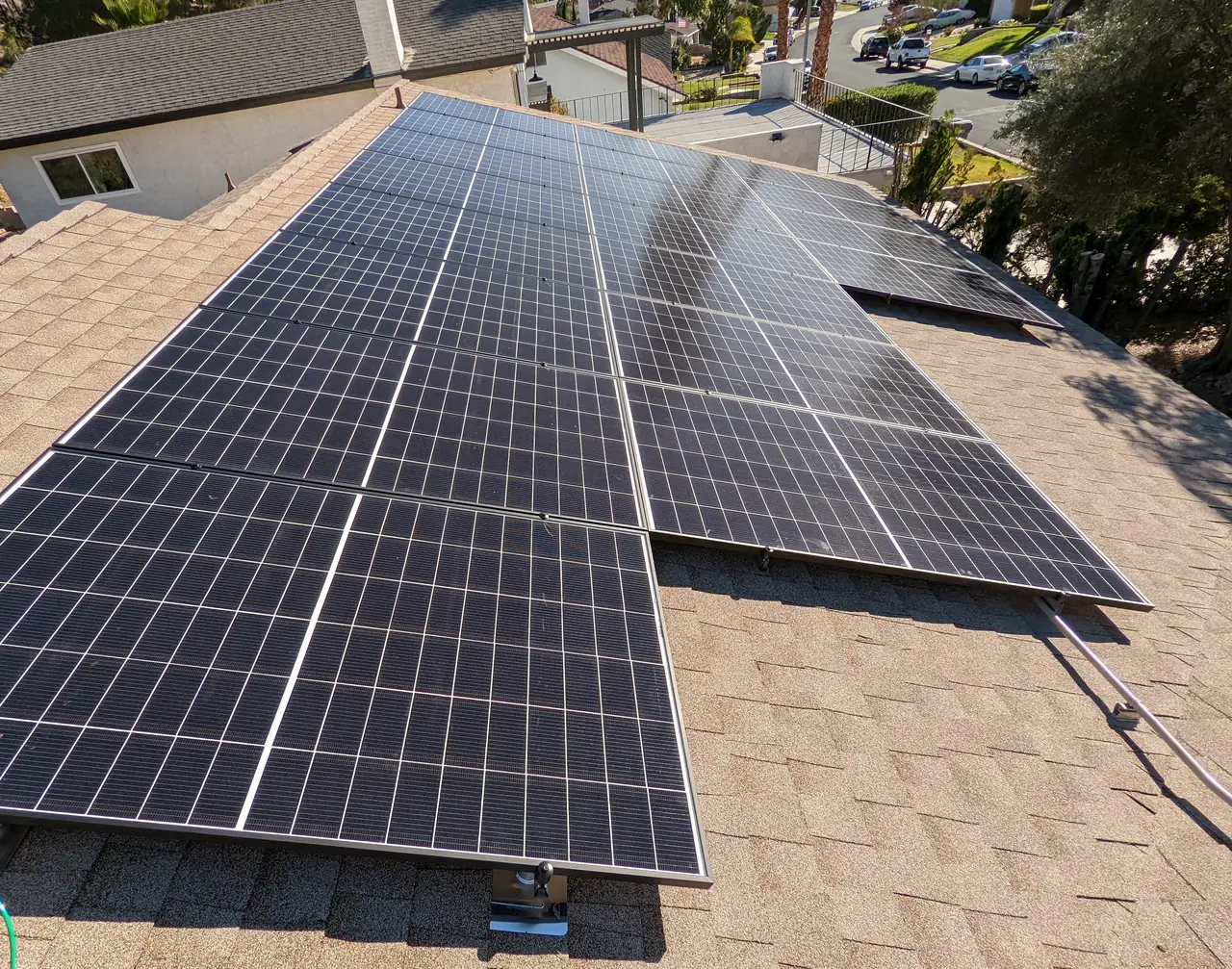 A finished rooftop solar array seen along the ridge with neighboring houses below, Santa Clarita