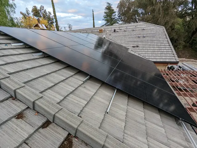 A large solar array on a tile roof, modules running up to the ridge, Santa Clarita