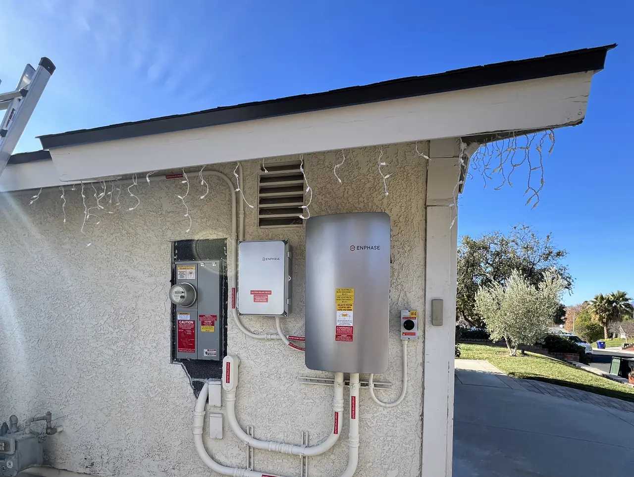 A house wall carrying a service panel, a gateway and a battery under the eave, Santa Clarita