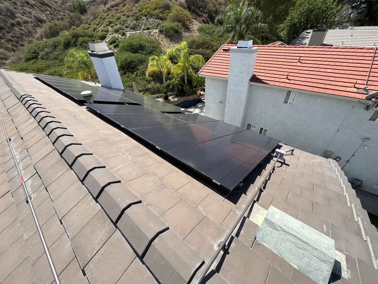 Solar modules beside a chimney on a tile roof, Santa Clarita