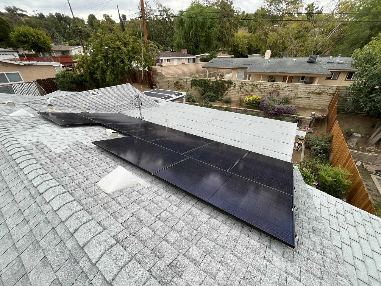 A shingle roof with the array and the neighborhood behind it, Santa Clarita