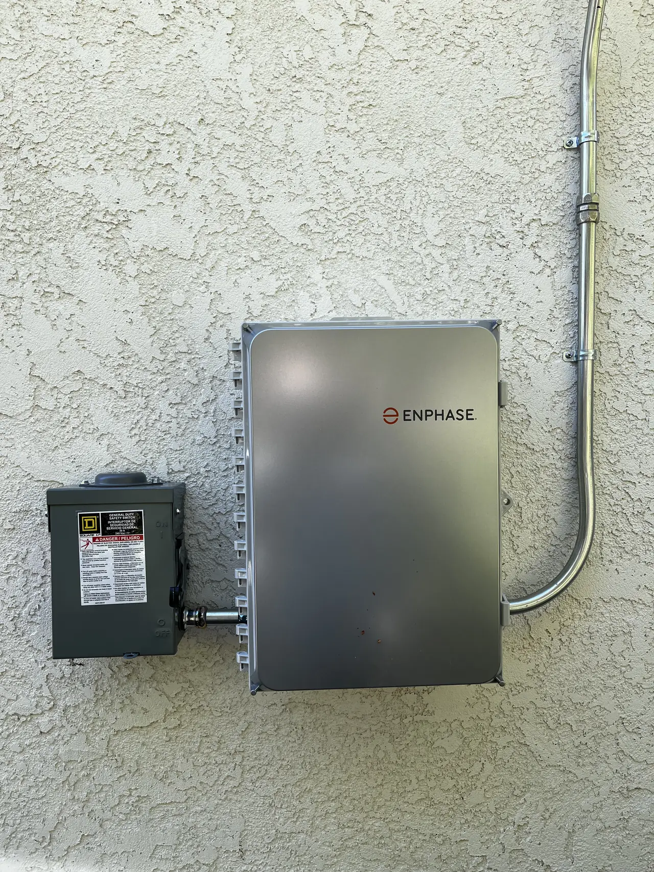 A closed combiner enclosure on a stucco wall, Santa Clarita