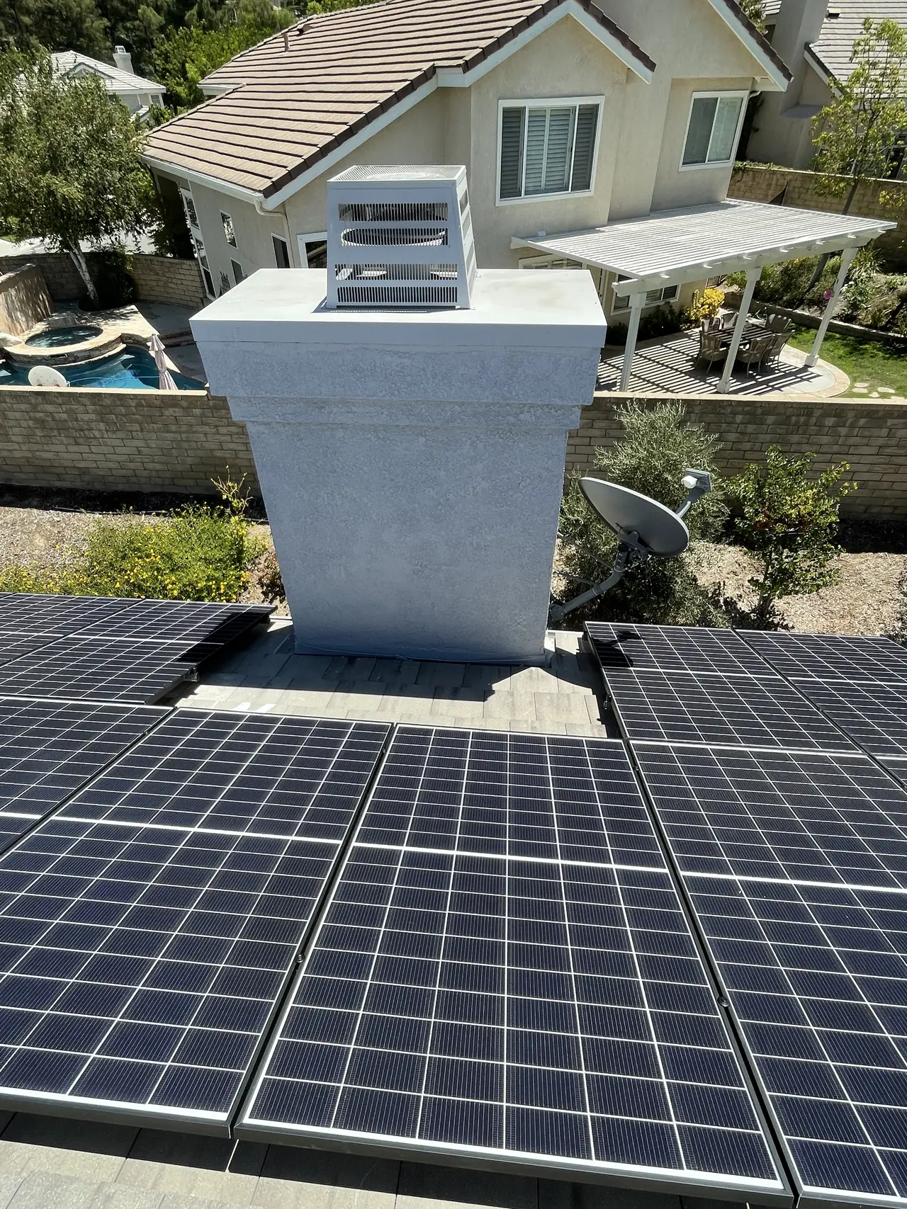 A solar array set around a chimney on a shingle roof, Santa Clarita