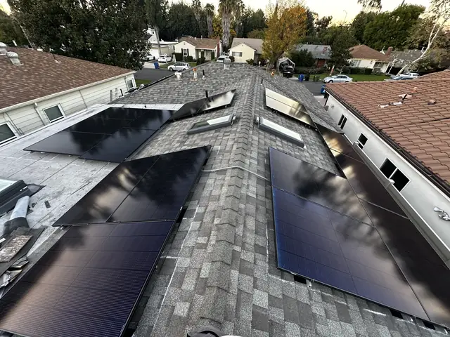 Solar modules on both slopes of a composition shingle roof in Sherman Oaks