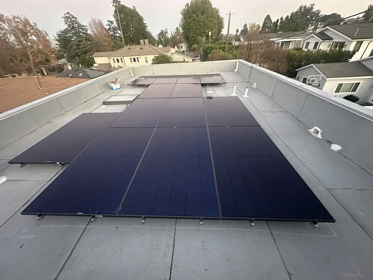 Solar modules laid out across a low-slope membrane roof on an accessory dwelling unit, Sherman Oaks