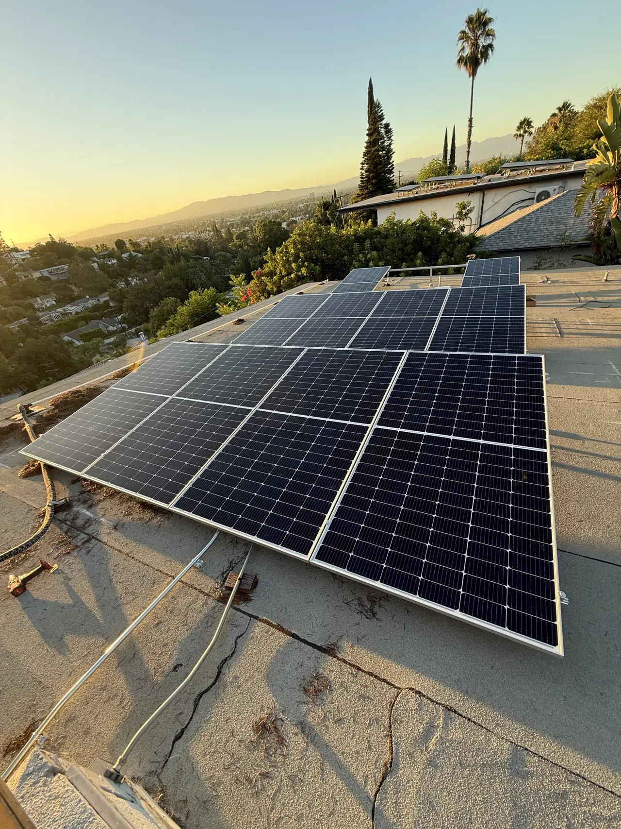 Solar array on tilt racking silhouetted against a low sun, Sherman Oaks