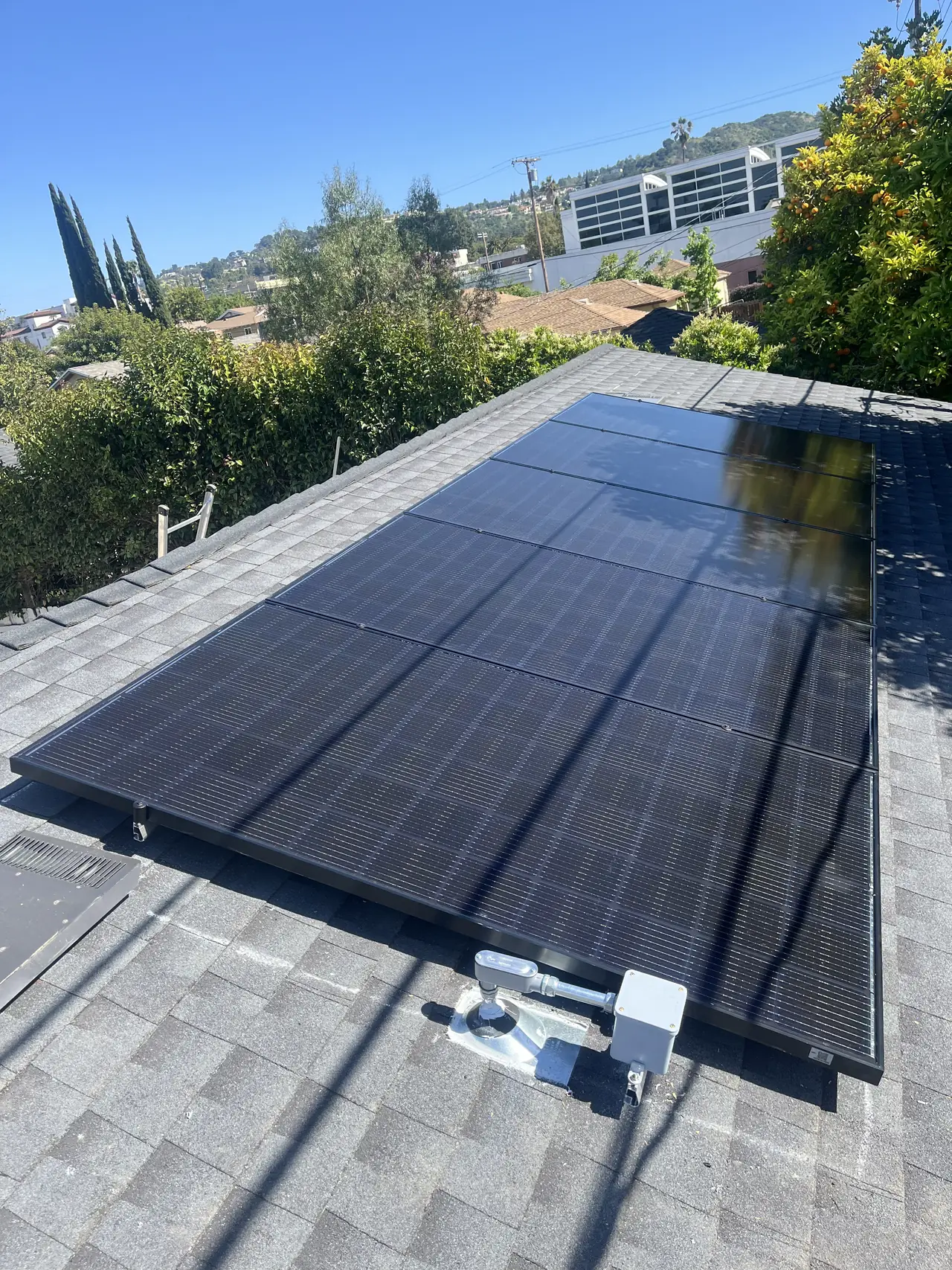 Solar modules on a shingle roof seen along the slope, Sherman Oaks