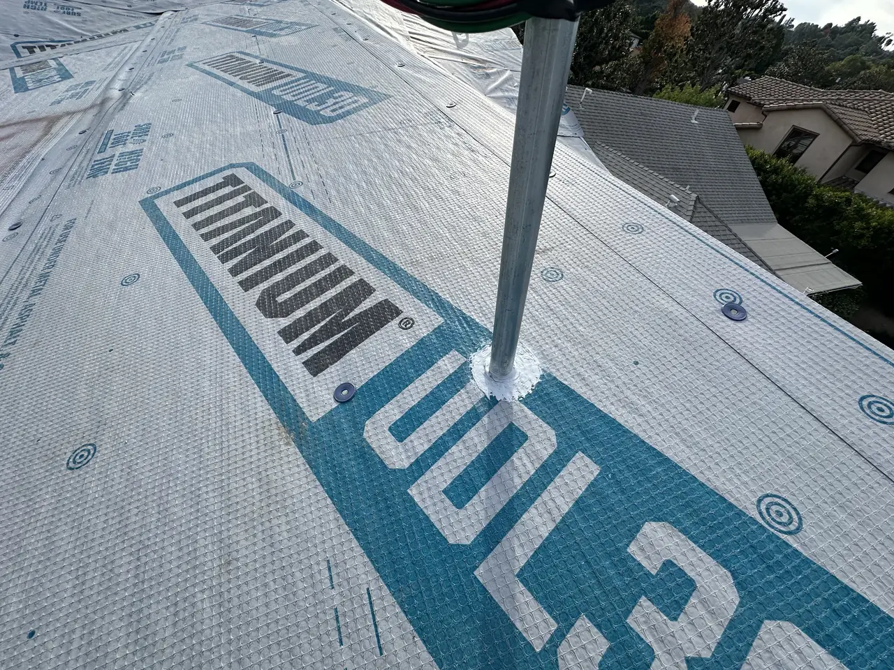Roof underlayment being laid over new sheathing before shingles, Sherman Oaks