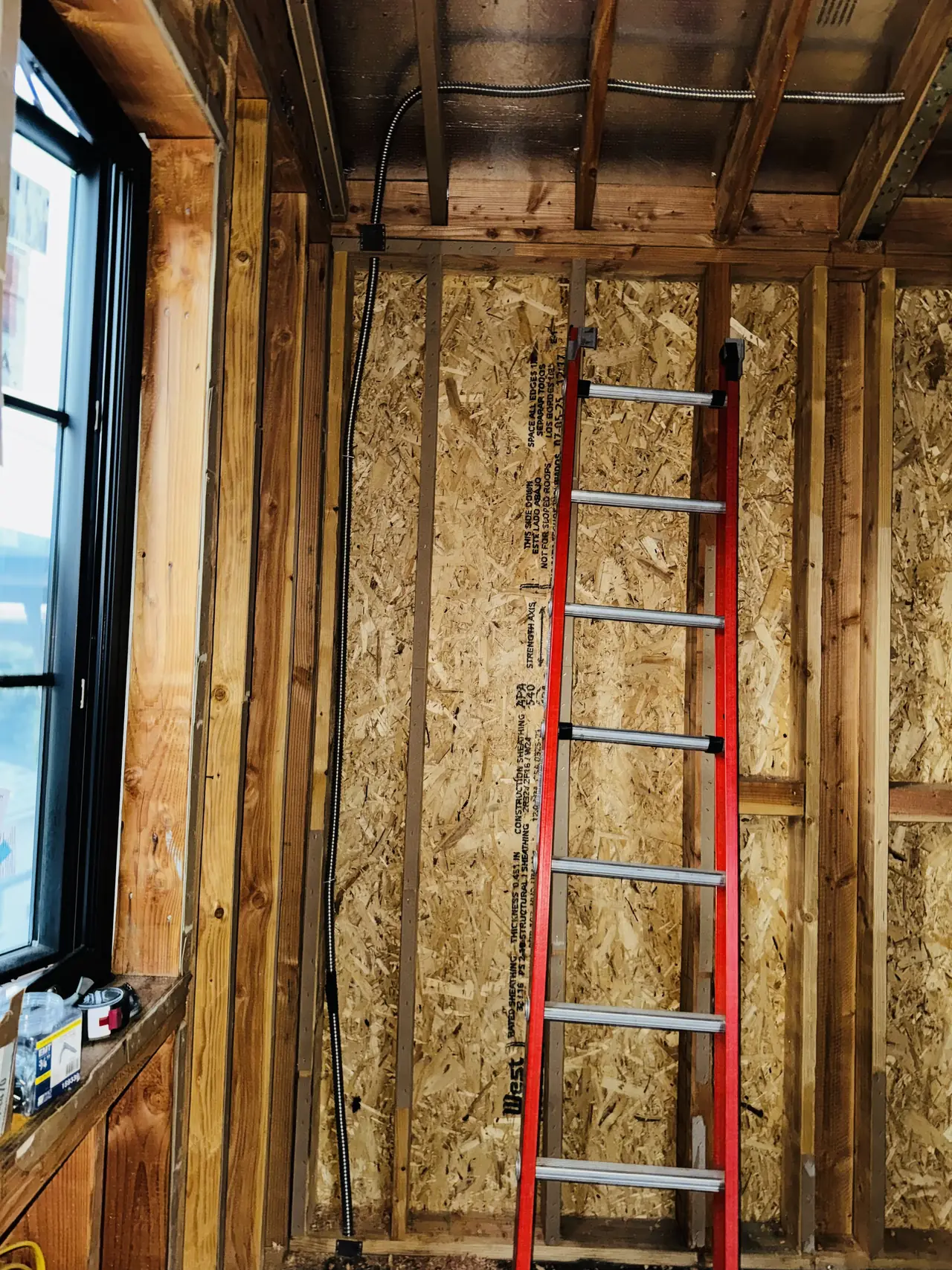 Electrical conduit running through open framing in a house under construction, Sherman Oaks