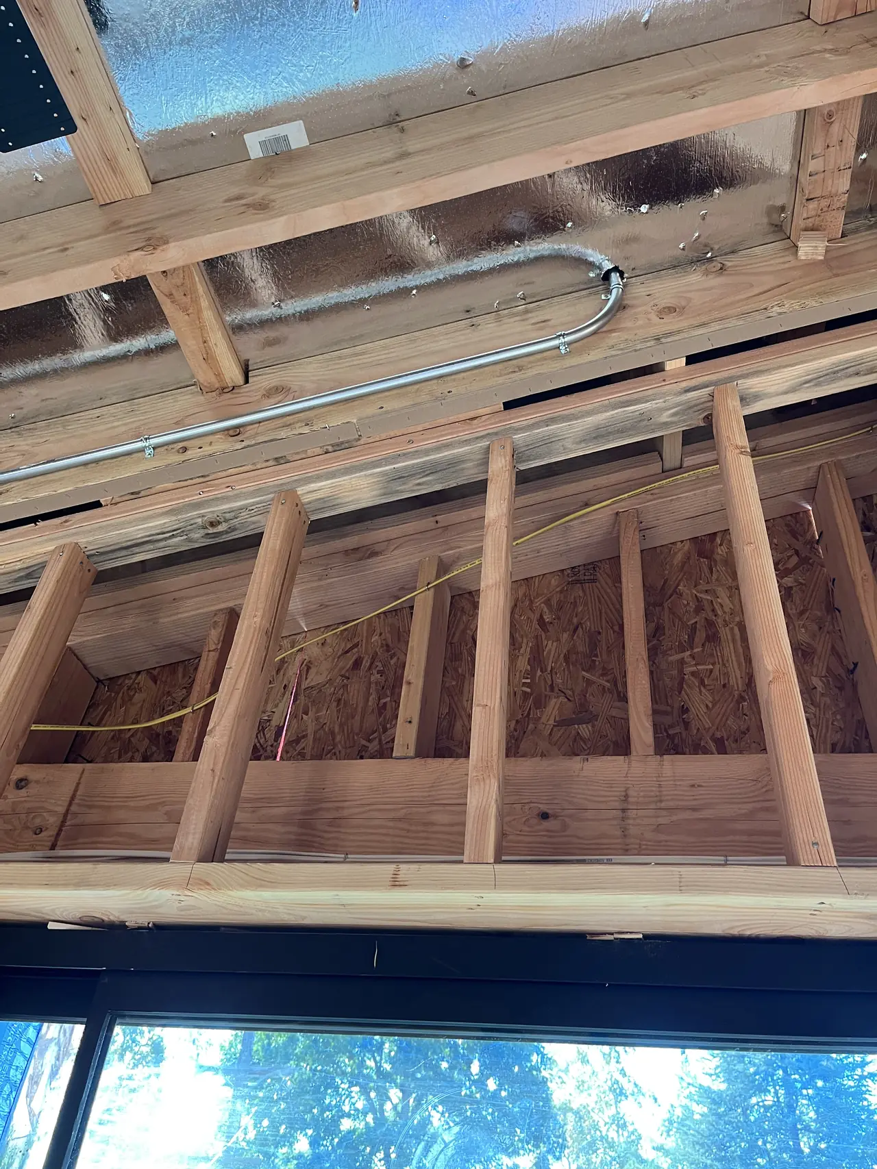 Electrical conduit run through open framing in a house under construction, Sherman Oaks