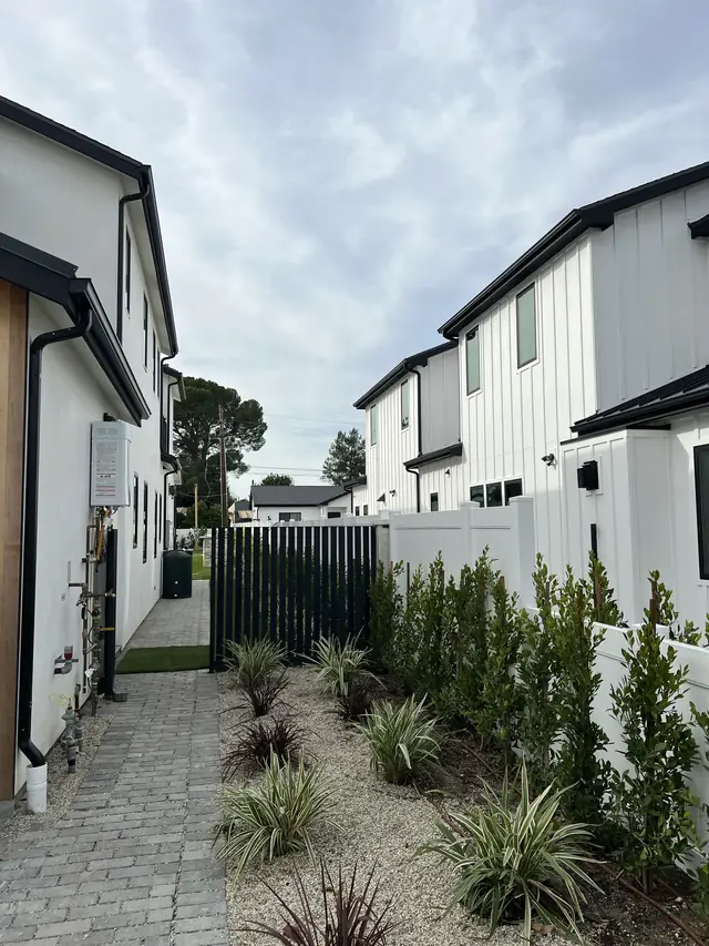 Two matching white two-story houses side by side in Sherman Oaks
