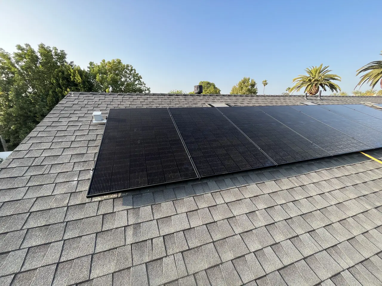 Solar modules seen along a shingle roof slope, Sherman Oaks