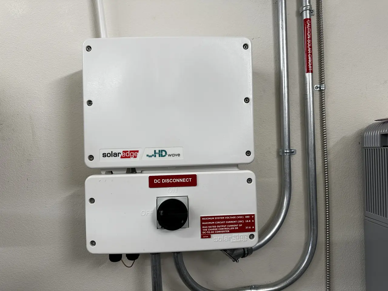 Inverter and alternating current disconnect mounted on a wall in Simi Valley