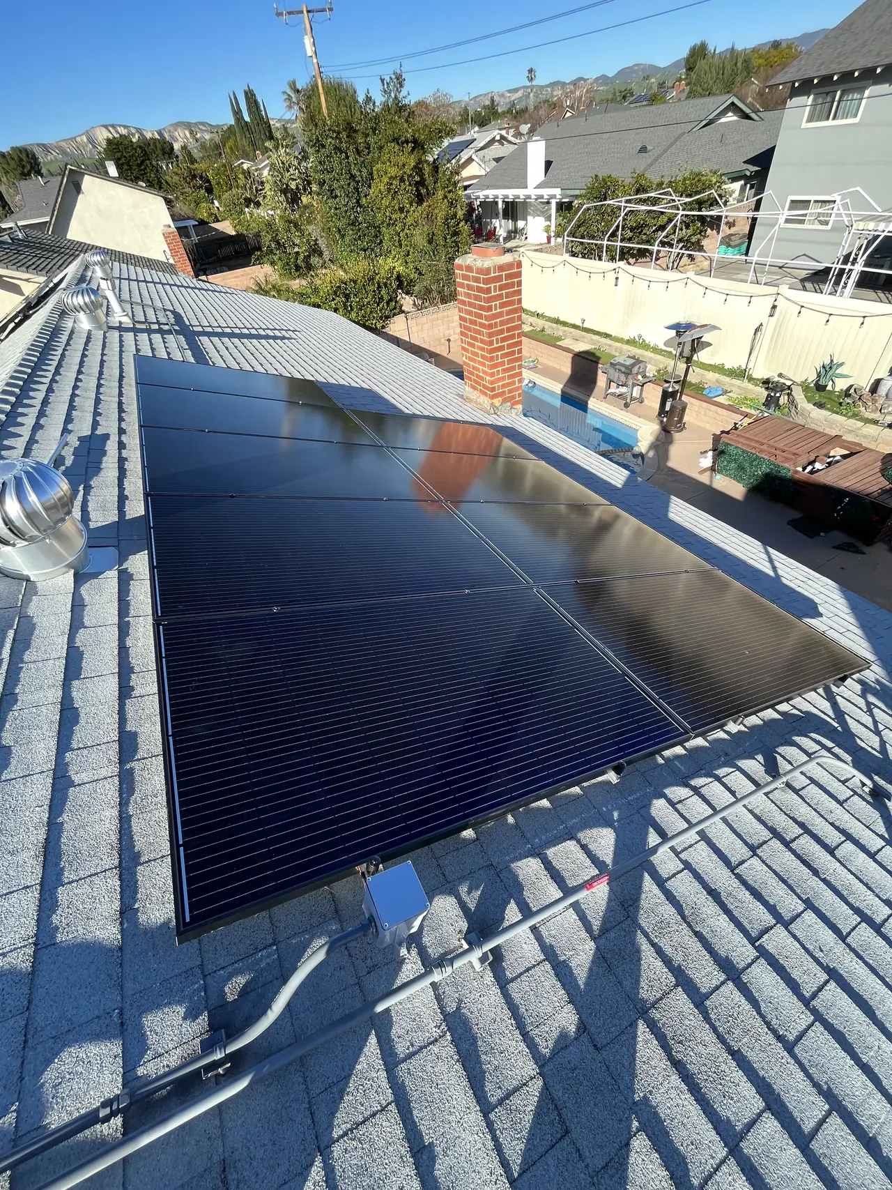 Solar modules being set onto rails on a Simi Valley roof