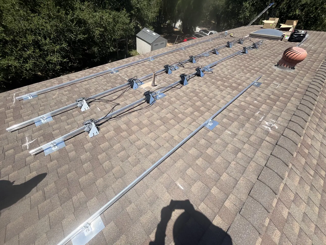 Mounting rails laid in short runs between roof vents on a Simi Valley roof