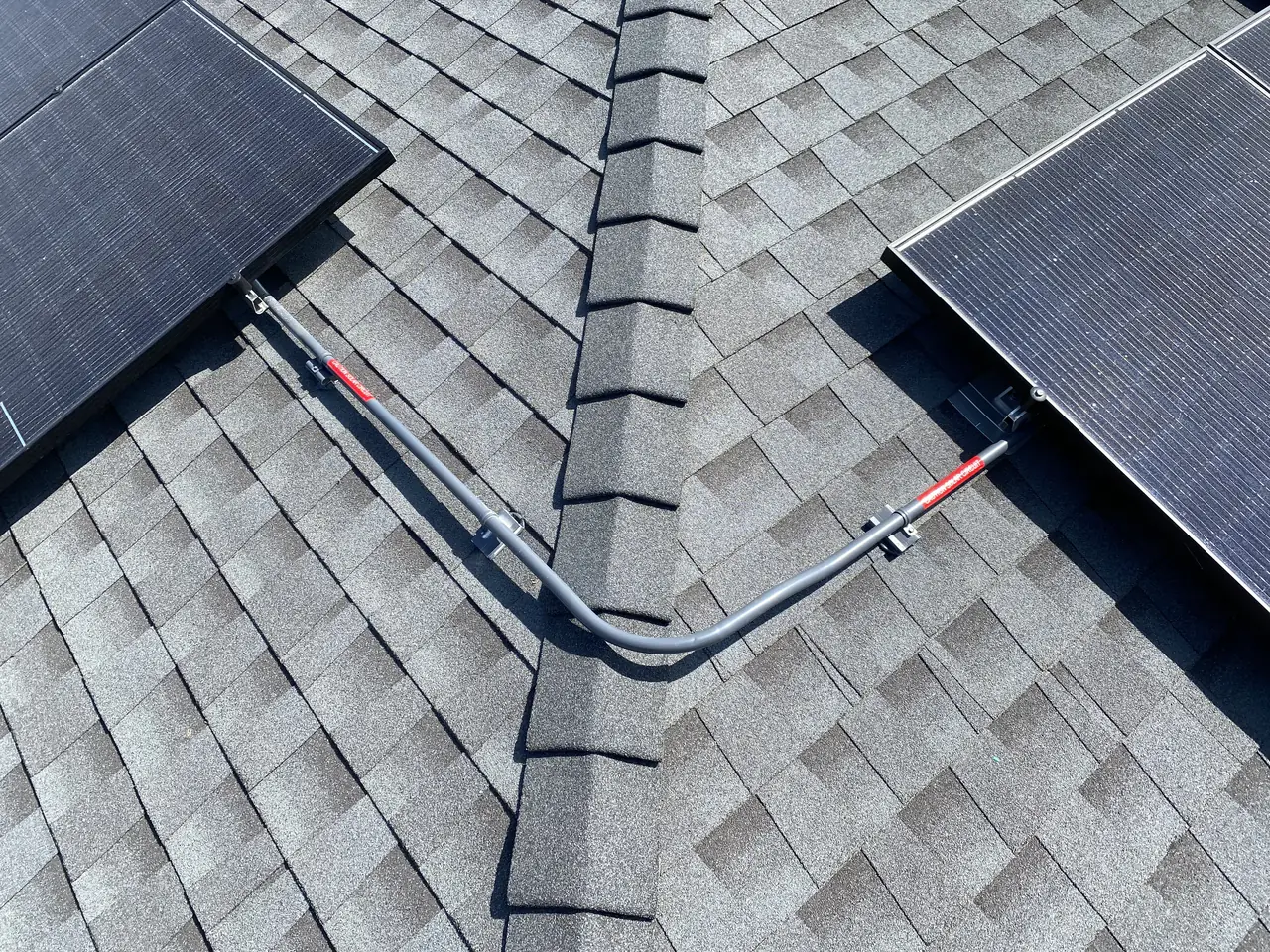 Conduit crossing the ridge of a shingle roof between two groups of solar modules, Studio City