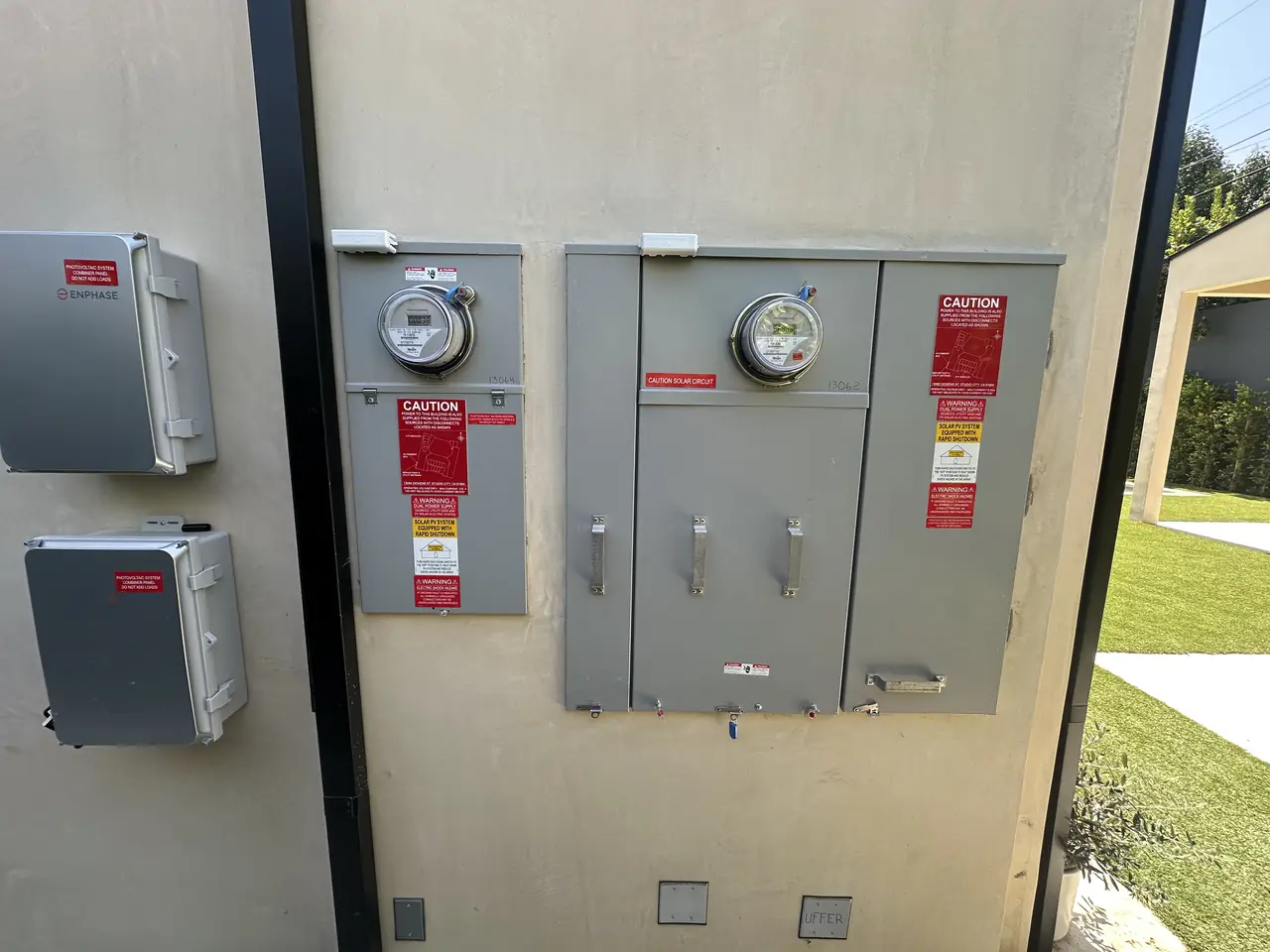 Two meter sockets and solar disconnects on a finished stucco wall, Studio City