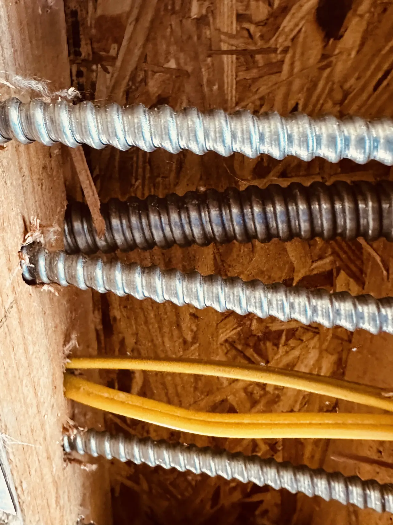 Electrical conduit running through open wall framing with insulation between the studs, Studio City