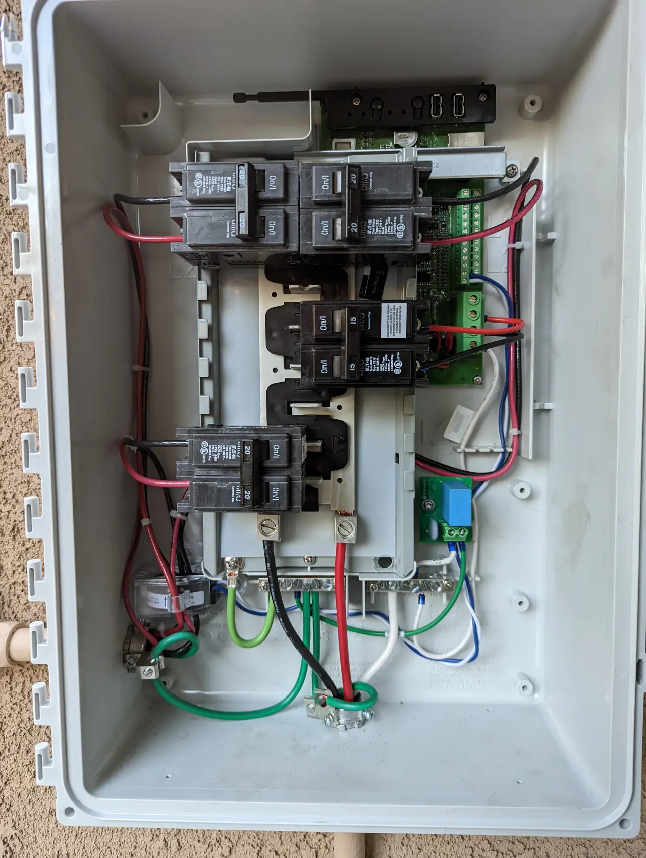 Open Enphase combiner enclosure with breakers and wiring, Sun Valley