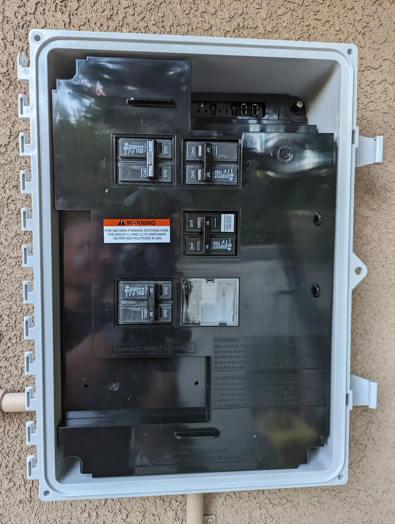 Enphase combiner mounted on an exterior wall beside the service equipment, Sun Valley