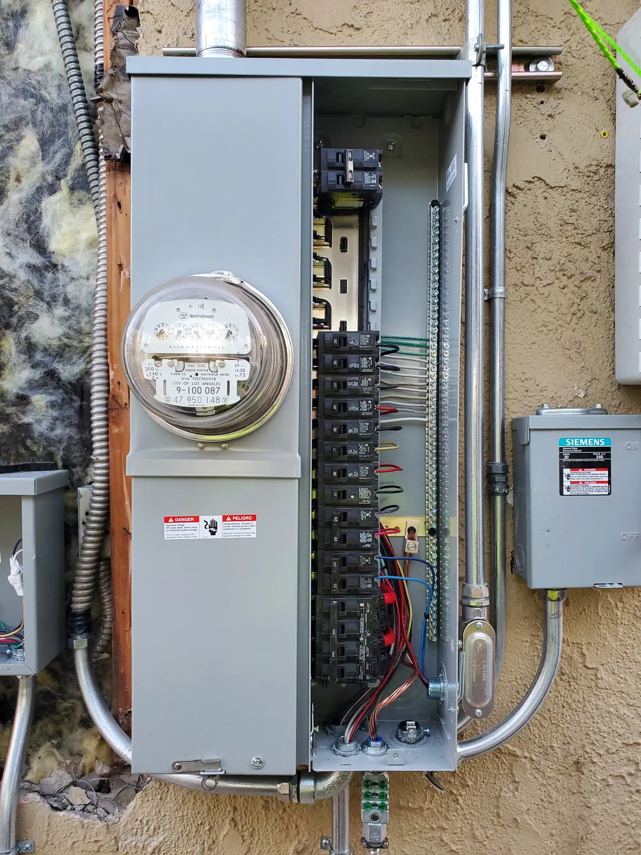 Service panel set into an exterior wall opening during replacement, Sun Valley