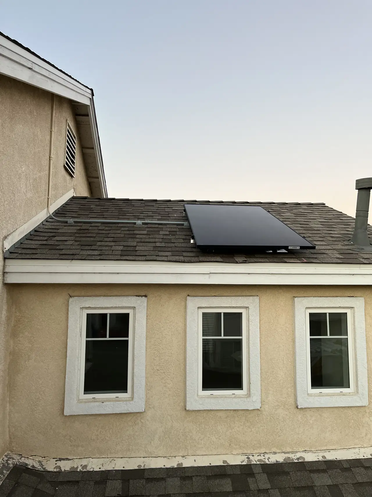 House exterior with solar modules visible on the roof, Sylmar