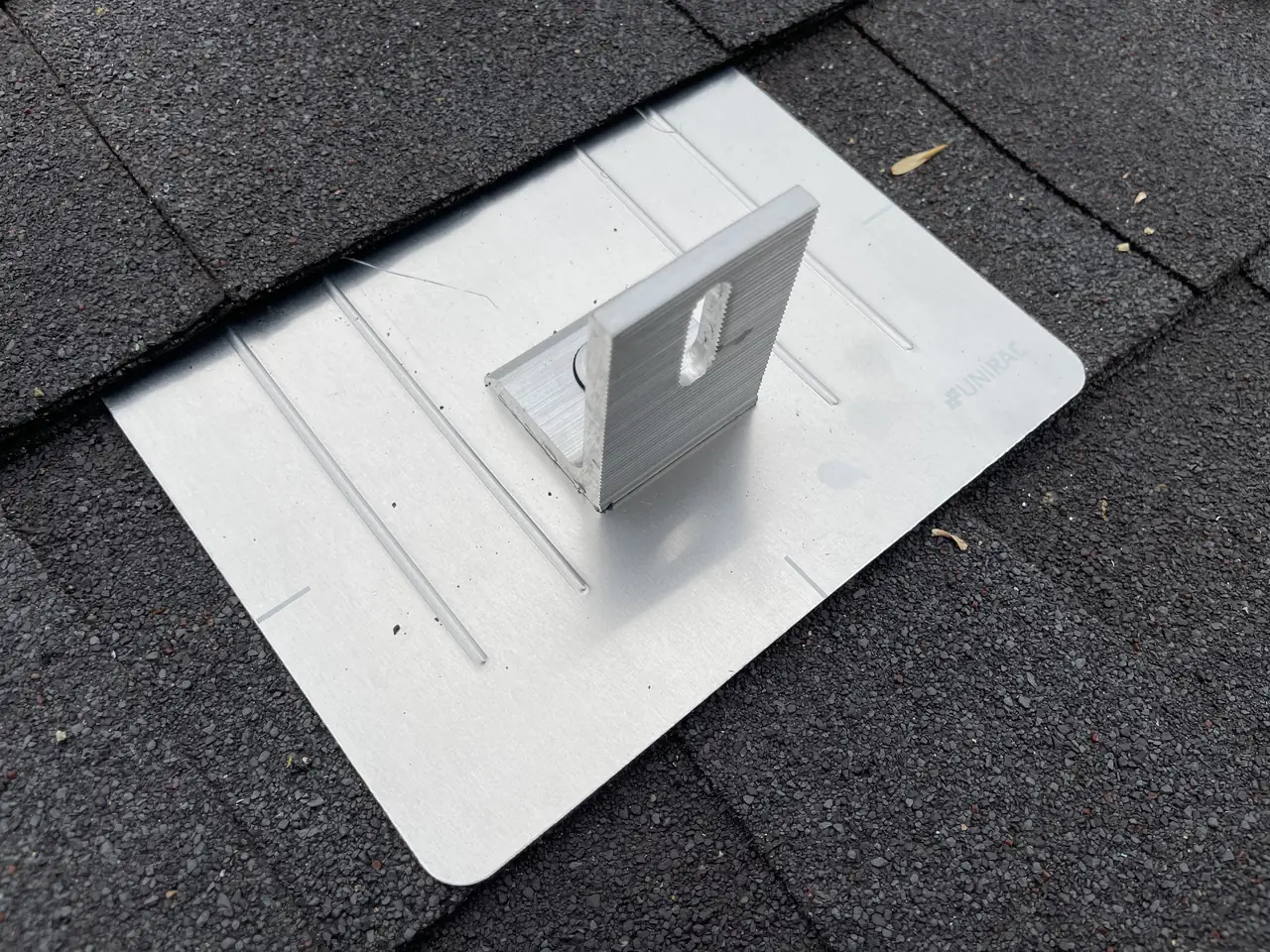 Flashed aluminum roof attachment with an L-foot on a new composition shingle roof, Tarzana