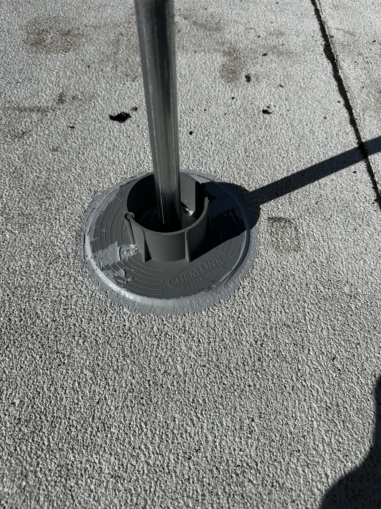 Flashed conduit boot sealed into a low-slope roof membrane, Tarzana