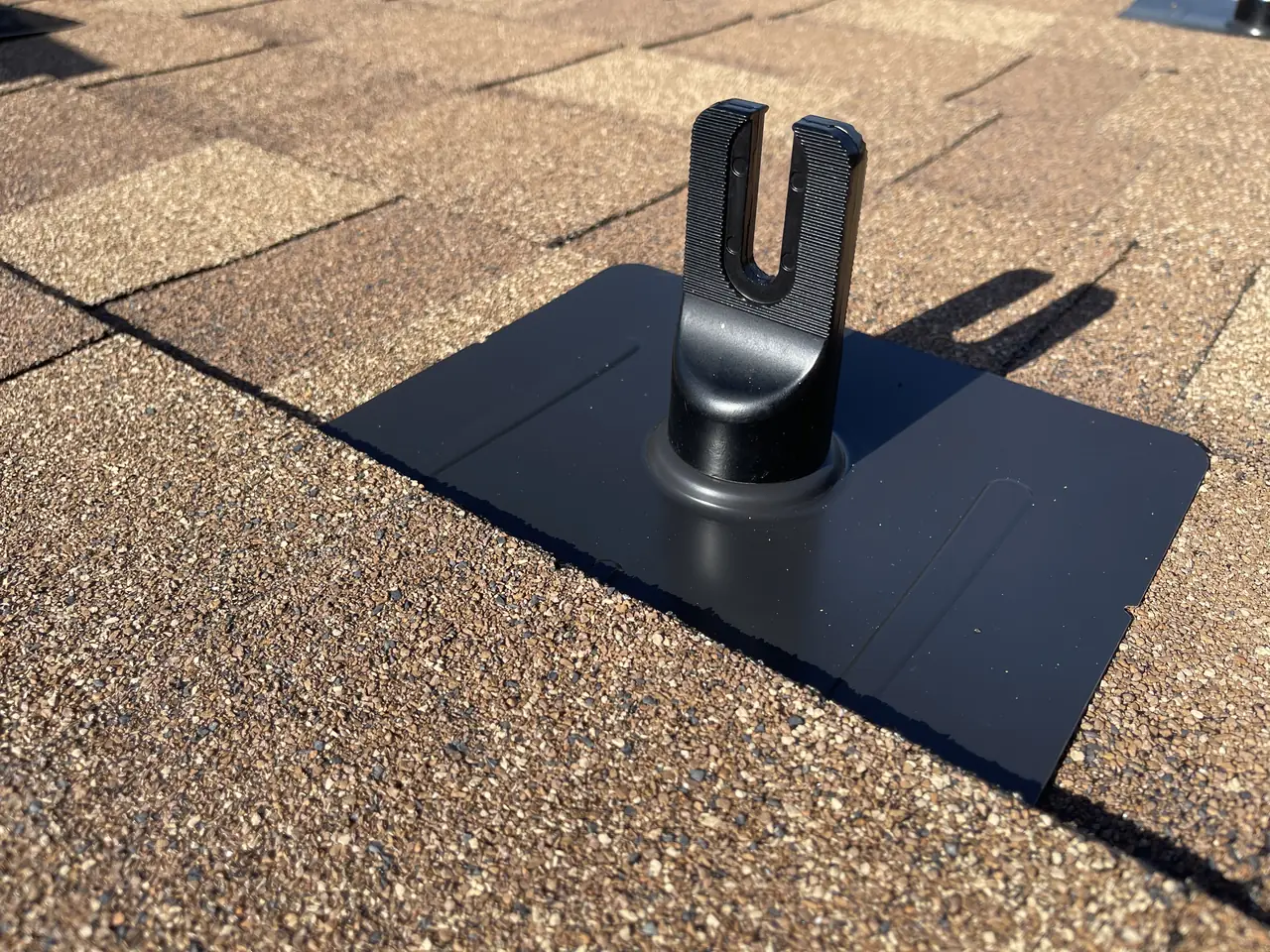 A black flashed solar mount on a brown shingle roof, Tujunga